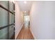 Hallway with wood floors leading to a bright, naturally lit room with neutral paint at 1612 Ruskin Way, Marietta, GA 30062