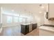 Stylish kitchen with a center island, modern appliances, and a seamless transition into the living area with hardwood floors at 1612 Ruskin Way, Marietta, GA 30062