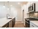Close-up of a modern kitchen featuring a center island, white cabinets, stainless steel appliances, and sleek countertops at 1612 Ruskin Way, Marietta, GA 30062