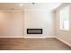 Contemporary living room with hardwood flooring, a modern fireplace, and a bright window showcasing a simple design at 1612 Ruskin Way, Marietta, GA 30062