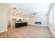 Open-concept layout with a modern fireplace, hardwood flooring, recessed lighting, and a clear view of the kitchen at 1612 Ruskin Way, Marietta, GA 30062
