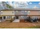 A view of the townhome's backyard, complete with a basketball hoop and a small concrete patio at 1670 Granville Ct, Lawrenceville, GA 30043