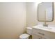 Modern half bathroom featuring new vanity, mirror, toilet and fixtures at 1670 Granville Ct, Lawrenceville, GA 30043