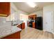 Updated kitchen featuring wood cabinetry, granite countertops, stainless appliances, and new flooring at 1670 Granville Ct, Lawrenceville, GA 30043