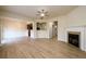 Open-concept living room with fireplace, ceiling fan, and wood flooring at 1670 Granville Ct, Lawrenceville, GA 30043