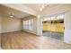 Bright living room featuring light wood flooring, modern light fixture, and sliding glass door to the outside at 1670 Granville Ct, Lawrenceville, GA 30043