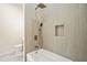 Bright bathroom with a soaking tub featuring modern fixtures and a tiled shower with a built in shelf at 237 Altoona Sw Pl, Atlanta, GA 30314
