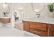 Stylish bathroom featuring a wood vanity with white marble countertop and a view into the adjacent living space at 237 Altoona Sw Pl, Atlanta, GA 30314