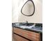 Contemporary powder room featuring a unique mirror, vanity, and marble countertop at 237 Altoona Sw Pl, Atlanta, GA 30314