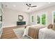 Modern bedroom featuring outdoor views, stylish console, and sliding barn door to the Primary bath at 237 Altoona Sw Pl, Atlanta, GA 30314