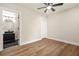 Bright, empty bedroom with hardwood floors and a peek at the bathroom at 237 Altoona Sw Pl, Atlanta, GA 30314