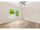 Bright bedroom with new wood-look floors and a large window overlooking a green yard at 237 Altoona Sw Pl, Atlanta, GA 30314