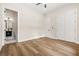 Light bedroom featuring wood-look floors, a modern ceiling fan and ensuite bathroom and double door closet at 237 Altoona Sw Pl, Atlanta, GA 30314