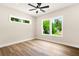 Sunlit bedroom with wood-look floors and large windows providing natural light at 237 Altoona Sw Pl, Atlanta, GA 30314