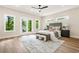 Well-lit bedroom with a large window, French doors, and bench seat at foot of bed at 237 Altoona Sw Pl, Atlanta, GA 30314