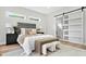 Cozy bedroom featuring modern furnishings, a gray headboard, and sliding barn door to the Primary at 237 Altoona Sw Pl, Atlanta, GA 30314