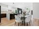 Open concept design showcases a dining area with stylish furniture, seamlessly connected to the modern kitchen and living area at 237 Altoona Sw Pl, Atlanta, GA 30314