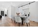 Bright dining area showcasing a sleek table, modern chairs, and seamless access to a living space through sliding barn doors at 237 Altoona Sw Pl, Atlanta, GA 30314