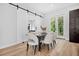 Bright dining room featuring a modern table and chairs, with access to the outdoor deck at 237 Altoona Sw Pl, Atlanta, GA 30314