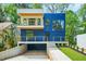 Modern home showcasing a striking blue exterior with a balcony and a well-manicured front yard at 237 Altoona Sw Pl, Atlanta, GA 30314