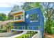 Modern home showcasing a striking blue exterior with a balcony and a well-manicured front yard at 237 Altoona Sw Pl, Atlanta, GA 30314