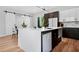Modern kitchen featuring a large island with stainless steel dishwasher and sliding barn door at 237 Altoona Sw Pl, Atlanta, GA 30314