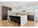 Modern kitchen boasts a central island with seating, sleek cabinetry, modern appliances, and stylish pendant lighting at 237 Altoona Sw Pl, Atlanta, GA 30314