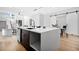 Modern kitchen with large island, featuring bar stool seating and pendant lighting at 237 Altoona Sw Pl, Atlanta, GA 30314