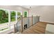 Bright landing featuring large windows with views of greenery and elegant wood and iron railings at 237 Altoona Sw Pl, Atlanta, GA 30314