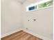 Bright laundry room features wood-look floors and a conveniently placed window for natural light at 237 Altoona Sw Pl, Atlanta, GA 30314