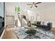 Comfortable living room featuring hardwood floors, a staircase, and ample natural light from large windows at 237 Altoona Sw Pl, Atlanta, GA 30314
