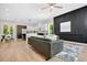 Inviting living area with hardwood floors, open to the kitchen and dining area, and a decorative accent wall at 237 Altoona Sw Pl, Atlanta, GA 30314