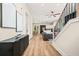 Bright, open-concept living area with hardwood floors, modern furnishings, and staircase at 237 Altoona Sw Pl, Atlanta, GA 30314