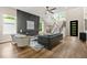 Open-concept living room showcasing hardwood floors, contemporary decor, and an eye-catching accent wall at 237 Altoona Sw Pl, Atlanta, GA 30314