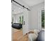 The open sliding barn door gives access to a light and airy living room at 237 Altoona Sw Pl, Atlanta, GA 30314
