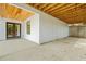 Open patio featuring wood beam ceiling, double glass doors and concrete floor at 237 Altoona Sw Pl, Atlanta, GA 30314