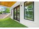 Inviting outdoor patio with artificial turf, wooden ceiling, and sliding glass doors into the home at 237 Altoona Sw Pl, Atlanta, GA 30314