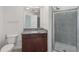 Bathroom features a granite countertop, wood vanity, large mirror, and glass enclosed shower at 250 Pharr Ne Rd # 318, Atlanta, GA 30305
