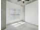 An open bedroom features exposed concrete pillars, a ceiling fan, and bright natural light at 250 Pharr Ne Rd # 318, Atlanta, GA 30305