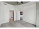 Bright bedroom with neutral carpet, white walls, concrete ceiling and two open doorways at 250 Pharr Ne Rd # 318, Atlanta, GA 30305