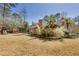 Expansive backyard with lush greenery, mature trees, play structure, and inviting patio area at 4970 Lakeland Woods Ct, Atlanta, GA 30338
