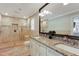 Well-appointed bathroom featuring a double vanity, walk-in shower, and tiled floors at 4970 Lakeland Woods Ct, Atlanta, GA 30338