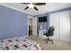 This is a bright bedroom featuring a ceiling fan and a large closet at 4970 Lakeland Woods Ct, Atlanta, GA 30338