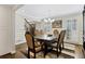 A formal dining room with a chandelier, hardwood floors, and elegant furnishings at 4970 Lakeland Woods Ct, Atlanta, GA 30338