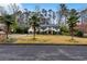Beautiful two-story home with a manicured lawn and lush landscaping, including palm trees at 4970 Lakeland Woods Ct, Atlanta, GA 30338