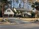 Inviting two-story home featuring a spacious driveway, mature trees, and meticulously landscaped front yard at 4970 Lakeland Woods Ct, Atlanta, GA 30338
