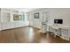 A bright home office with custom built-in cabinetry, a desk, and hardwood floors at 4970 Lakeland Woods Ct, Atlanta, GA 30338