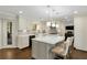 A bright kitchen with a central island, white cabinets, stainless steel appliances, and hardwood floors at 4970 Lakeland Woods Ct, Atlanta, GA 30338