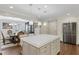 Open-concept kitchen features a large island, stainless steel appliances, and adjacent dining area at 4970 Lakeland Woods Ct, Atlanta, GA 30338