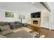 A spacious living room with a stone fireplace, built-in shelving, and hardwood floors at 4970 Lakeland Woods Ct, Atlanta, GA 30338